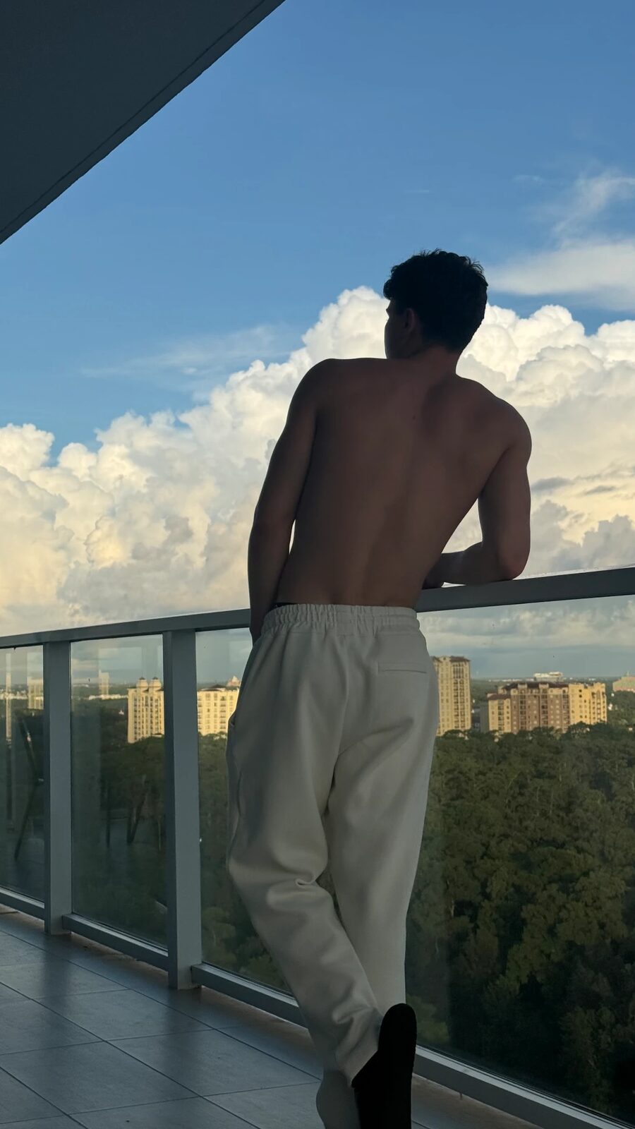 Jaxon Avery from behind, overlooking the city skyline